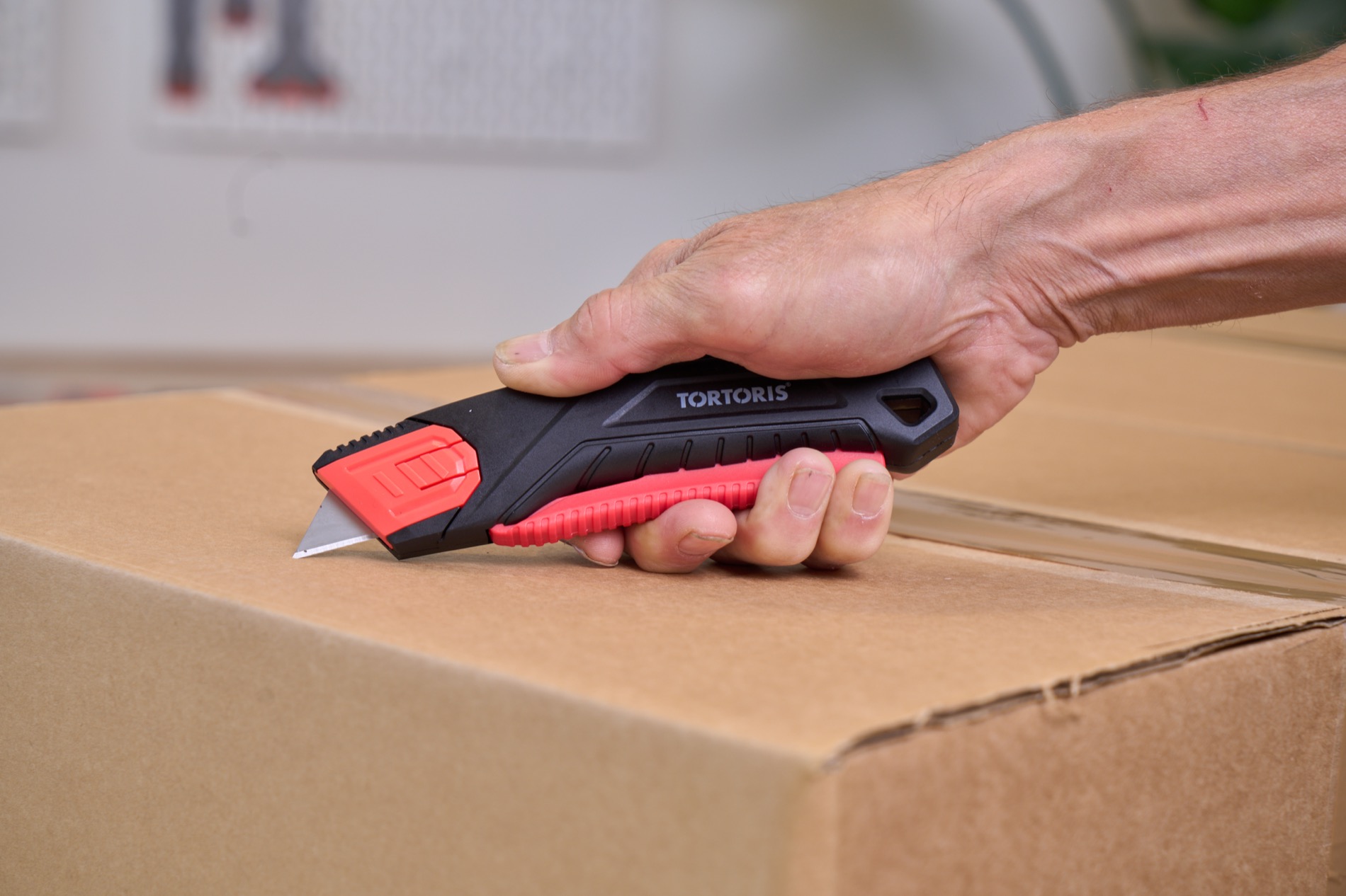 TORTORIS safety knife cutting open a cardboard box